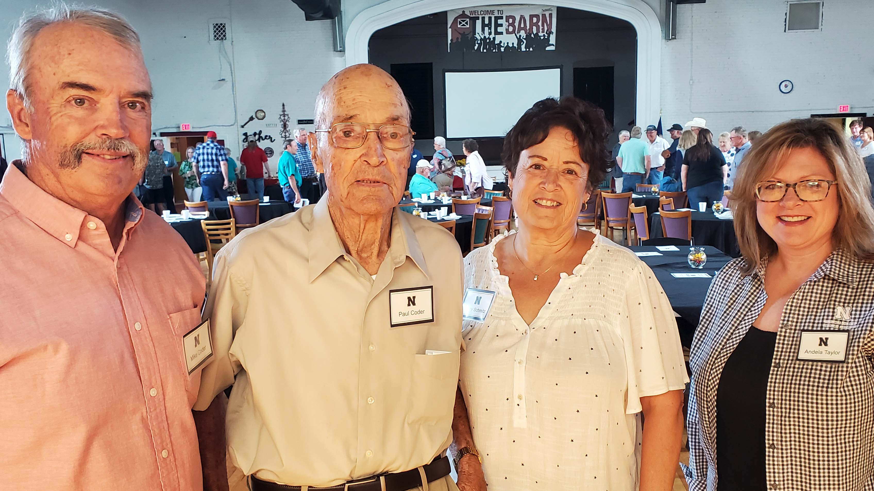 The "Curtis ag school" and beef cattle were among conversations at Aggie Alumni Day for Paul Coder, Class of '46, with his son Mike Coder, daughter Nancy Schmitz, and NCTA recruiting coordinator Andela Taylor. (M. Crawford photo / NCTA News)