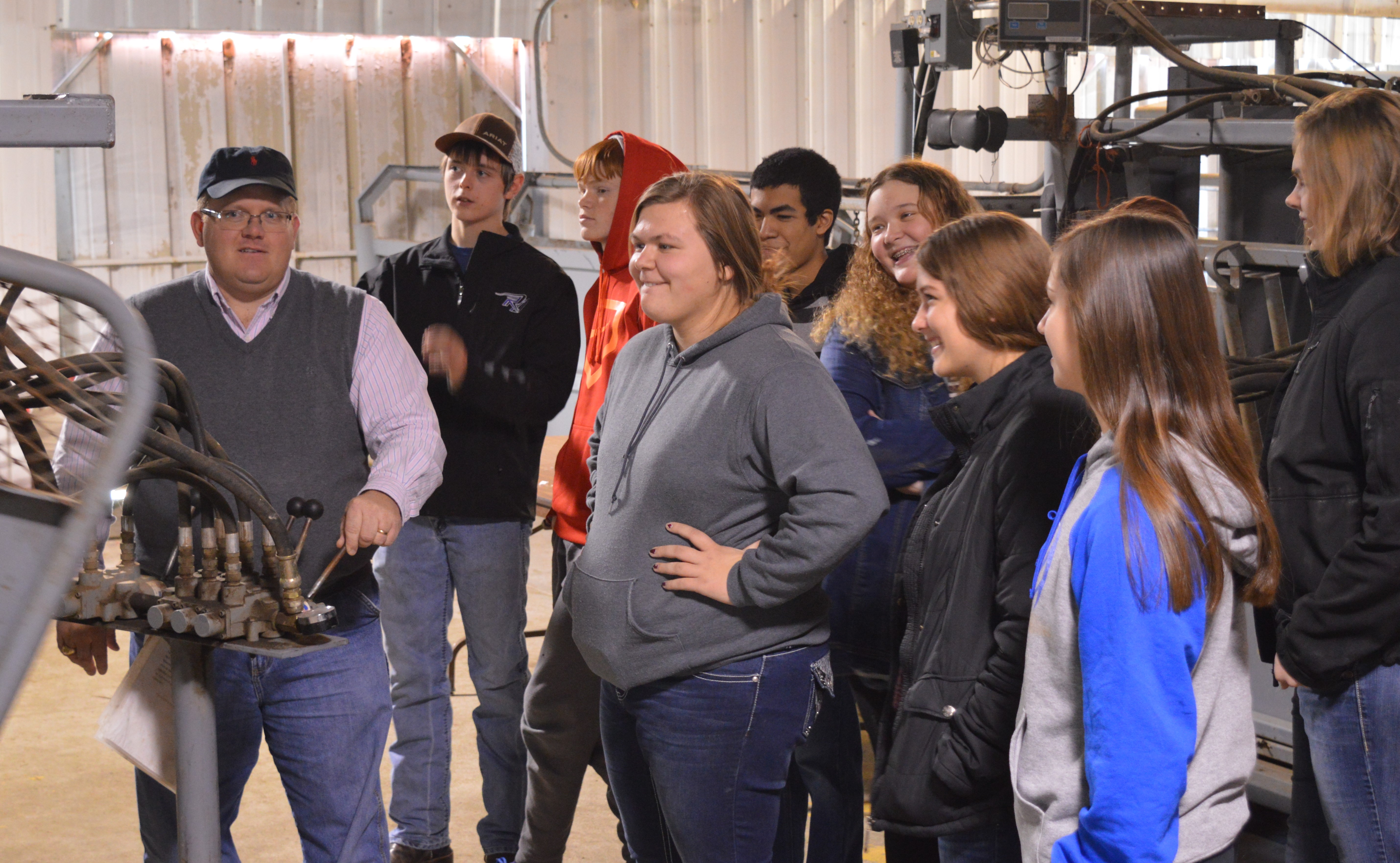 North Platte students observe Dr. Doug Smith demonstrate equipment for processing cattle during health checkups at the NCTA Red Barn. Students visited campus last year to see animal science in action. (NCTA photo)