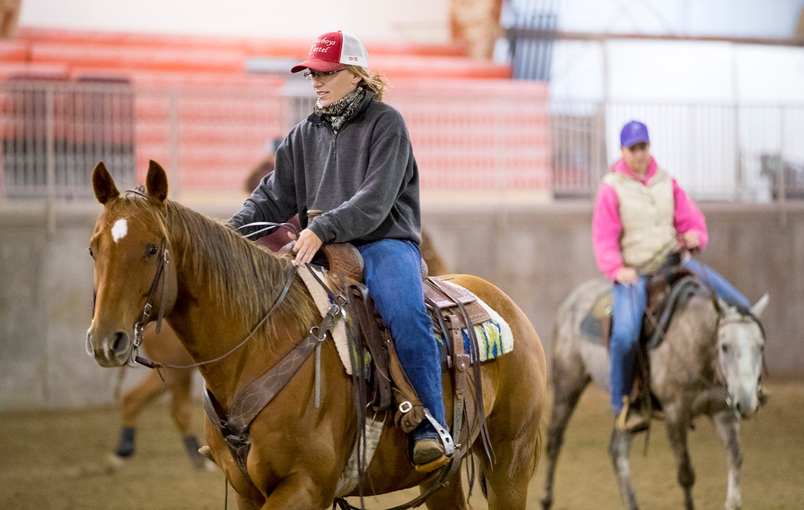 Makayla Forsythe, NCTA Ranch Horse team member and Livestock Teaching Center facilities student manager, works out with, Gill, at the NCTA indoor arena. (NCTA Photo by Craig Chandler / University Communication.)