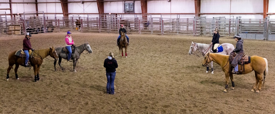 NCTA Ranch Horse team members discuss upcoming competitions with Coach Joanna Hergenreder. (NCTA/Craig Chandler Photo)