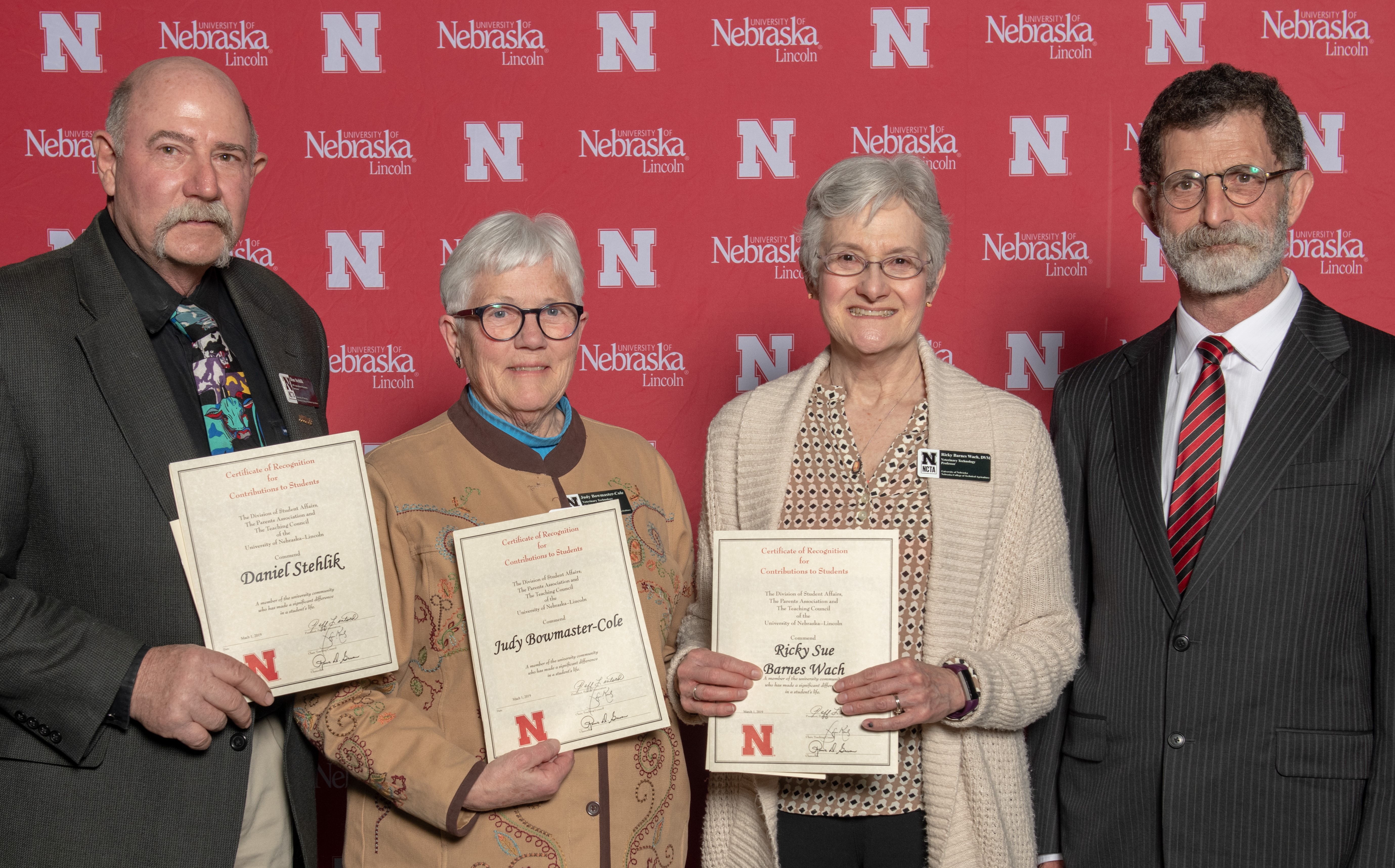 Dan Stehlik, Judy Bowmaster-Cole and Ricky Sue Barnes Wach, DVM, were recognized March 1 by the UNL Parent Association. NCTA Dean Ron Rosati applauds their dedication to students. (UNL University Communication)