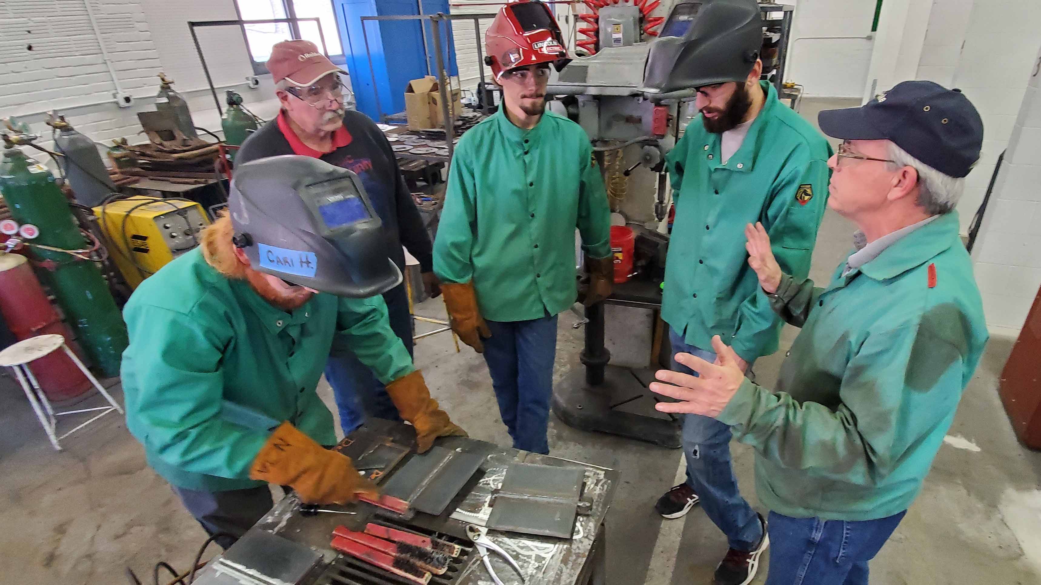 Certified Welding Inspector Chuck Hatzenbuehler (far right) describes the national certification criteria to (from left) Dalton Olsen, instructor Dan Stehlik, Clancey Smith and Sam Schukei. (Photo by Crawford / NCTA News)