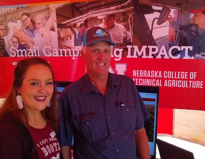 NCTA ag education major Audrey Heinz of Eaton, Colorado, visits with NCTA alumnus Conrad Nelson, who farms near Wallace about student programs. (M.Crawford/NCTA News photo)
