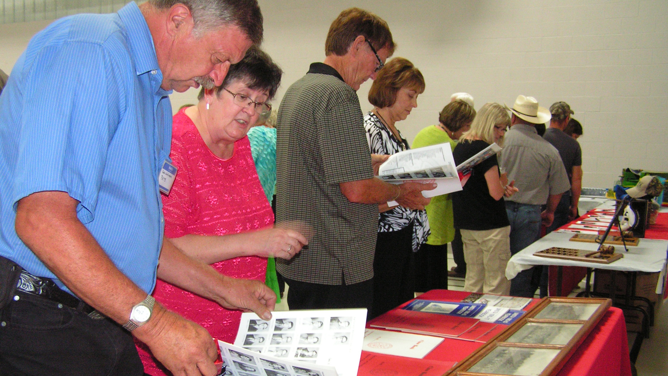 Alumni and friends view memorabilia such as Aggie class annuals and historical photographs in August 2013, celebrating the 100th anniversary of the Curtis Aggie campus. (Photo by Mary Crawford / NCTA)