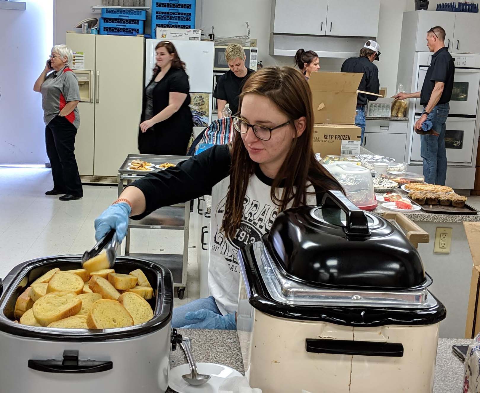 NCTA student Sadie Christensen of Arnold serves food at the NCTA pasta benefit in Curtis on March 26.  (Meredith Cable / NCTA photo) 