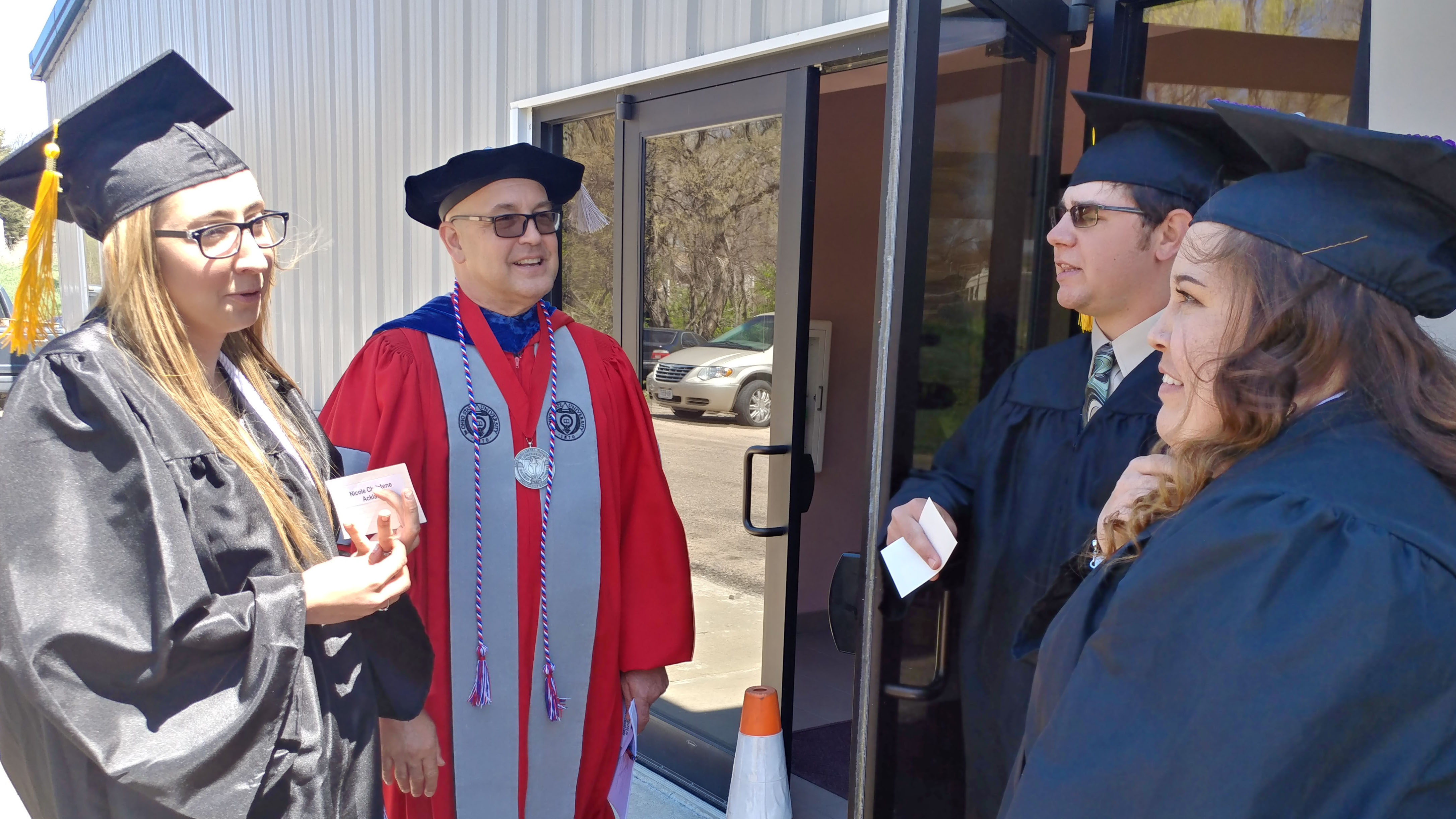 Three graduates from the Class of 2019 at the Nebraska College of Technical Agriculture chat with University of Nebraska Vice President Mike Boehm prior to commencement in Curtis. In 2020, graduation was a virtual event. (Crawford / NCTA file photo)
