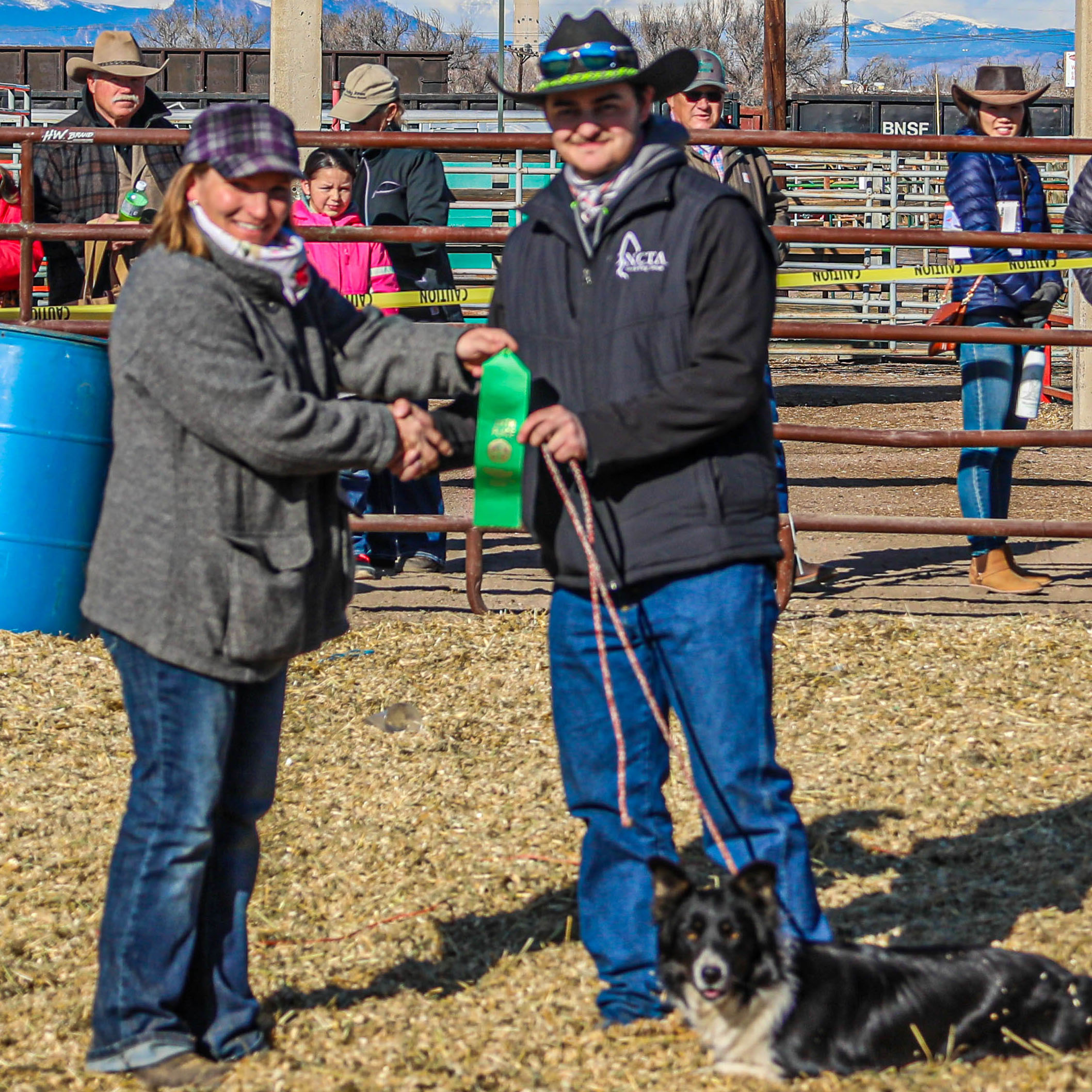 NCTA “Aggie of the Year” CJ Monheiser of Hershey, Nebraska, at right, competed at the National Western Stock Dog Trials at Denver in January, with his dog, Addie. (NCTA / XP Ranch Photography)