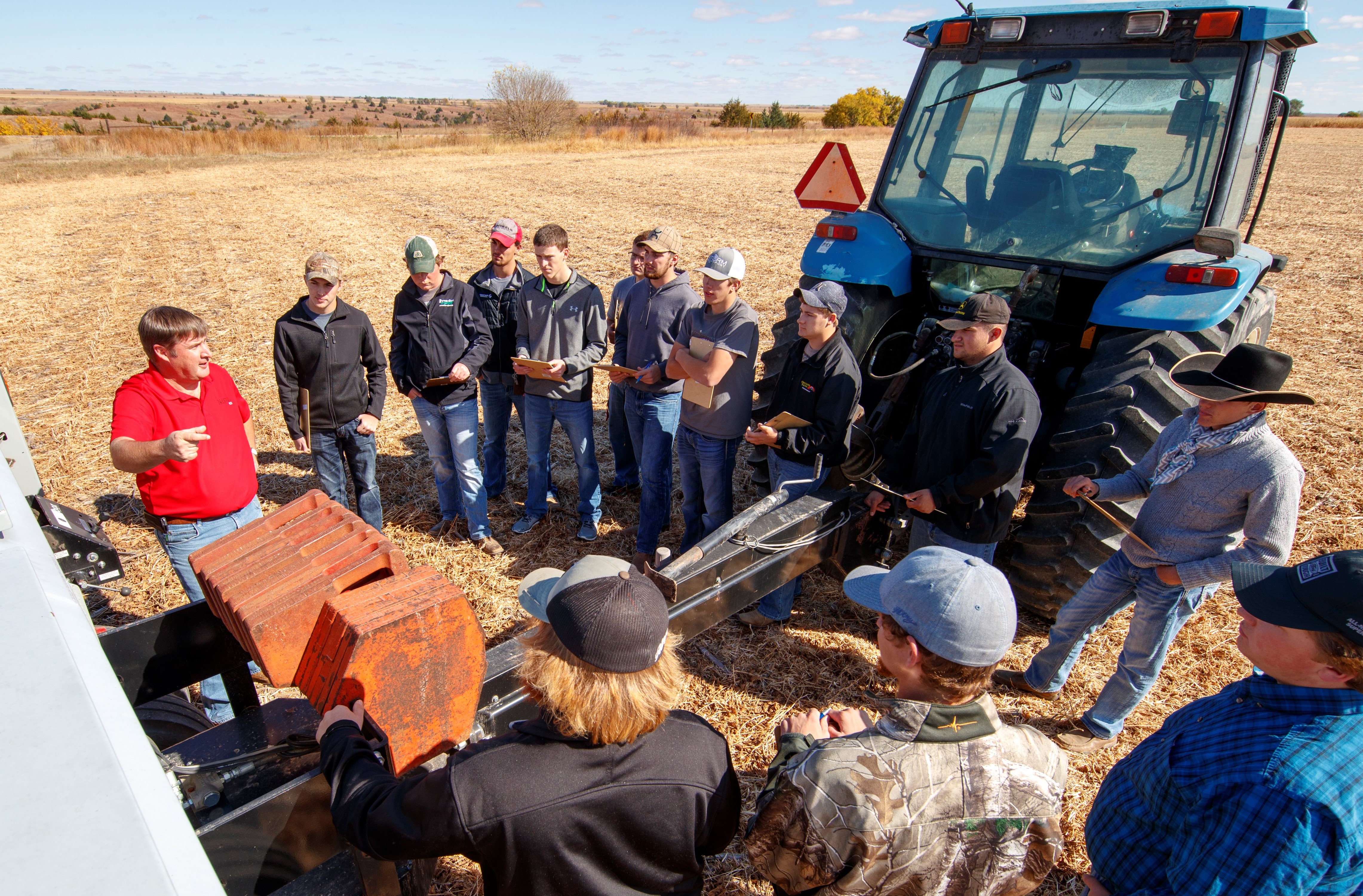 Agronomy professor Brad Ramsdale discusses seeding rate and grain drill calibrations with NCTA students at the college farm. (Craig Chandler / University Communication Photo)