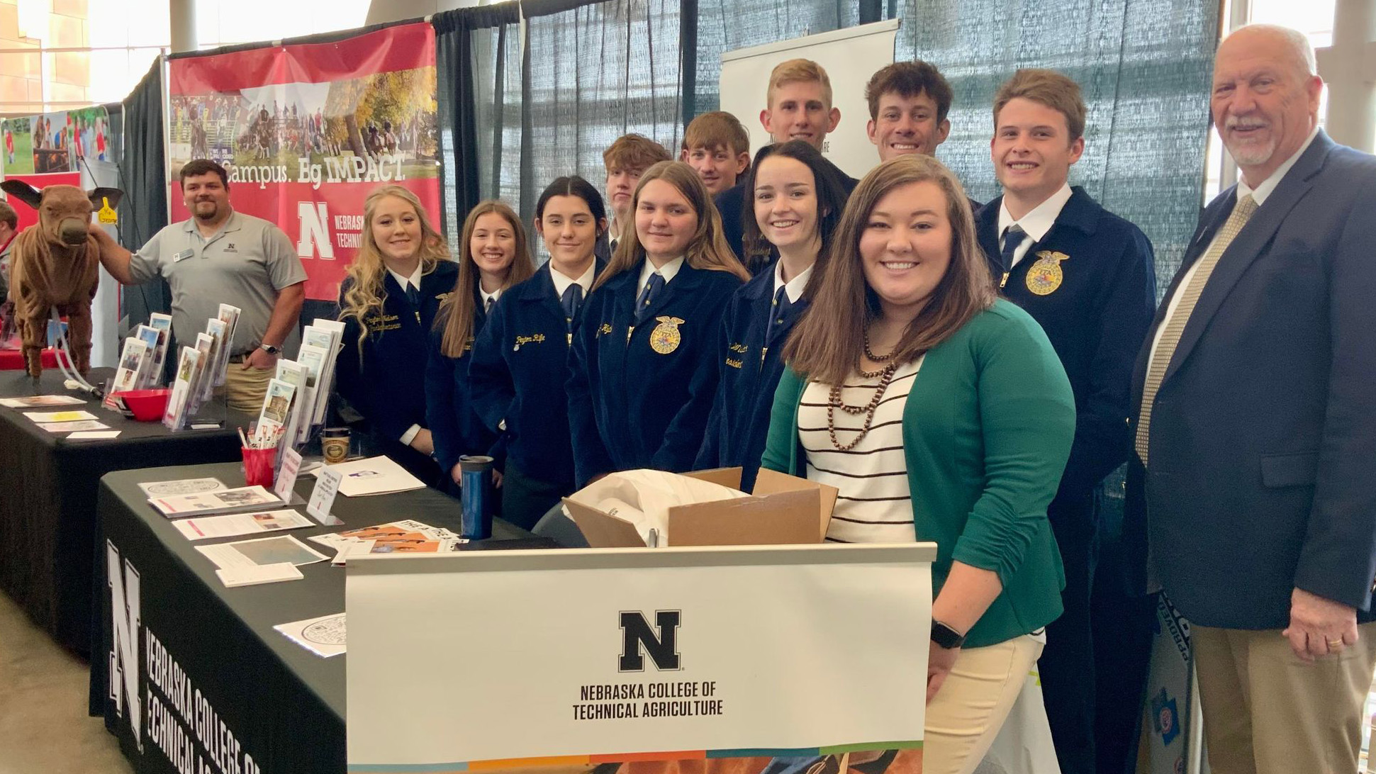 Kayla Mues (front, right) is advisor with the Dundy County-Stratton FFA Chapter. The NCTA alumna brought students by the Nebraska College of Technical Agriculture exhibit during the 94th Nebraska FFA Convention. (Photo by Andela Taylor / NCTA)