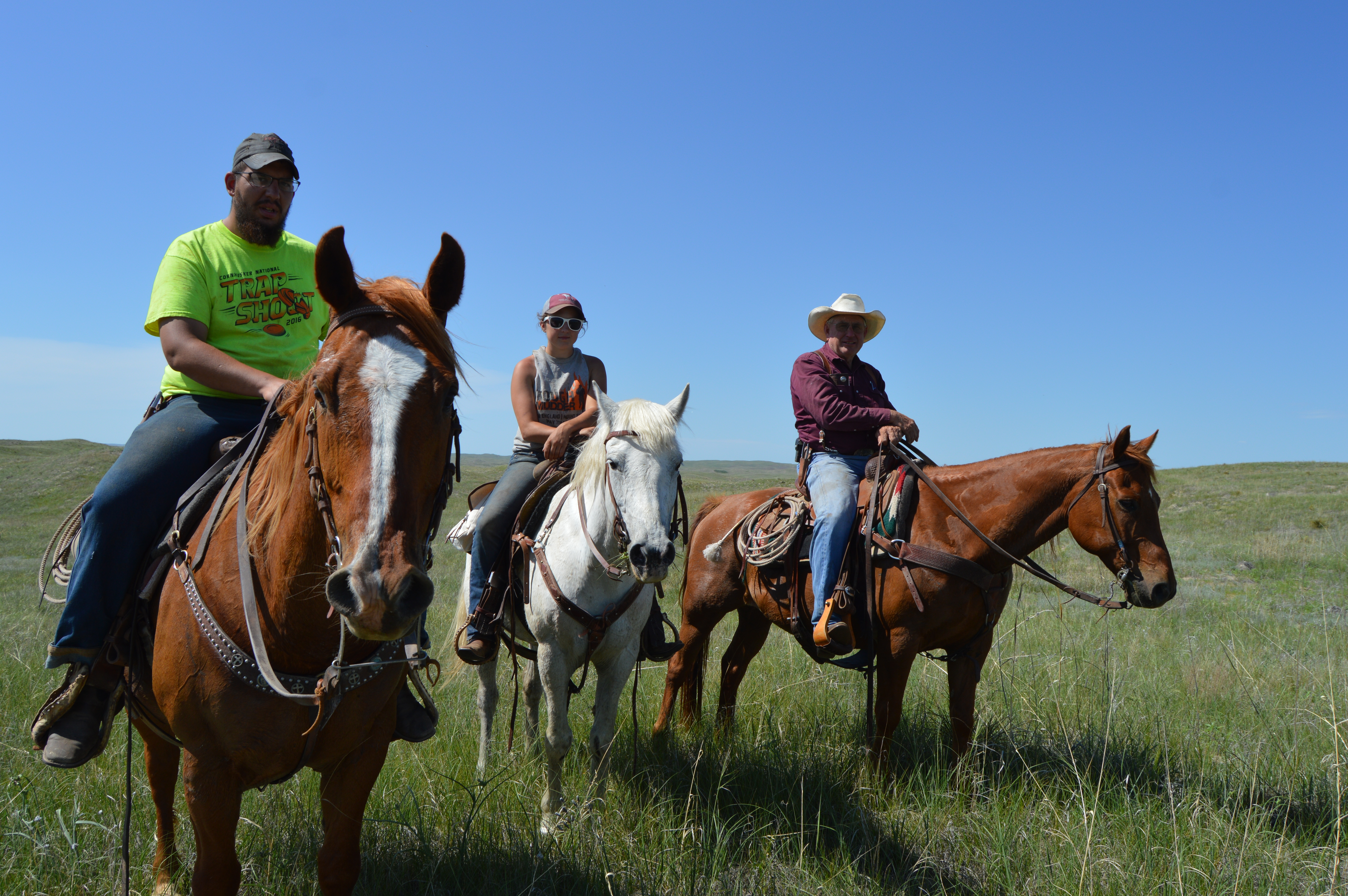 Roy Cole, far right, is assisted in moving cattle at the Graves Ranch by students Cassie Bratton and Cody Brown who are serving their summer internship with the NCTA farm crew. (Crawford/NCTA News photo)