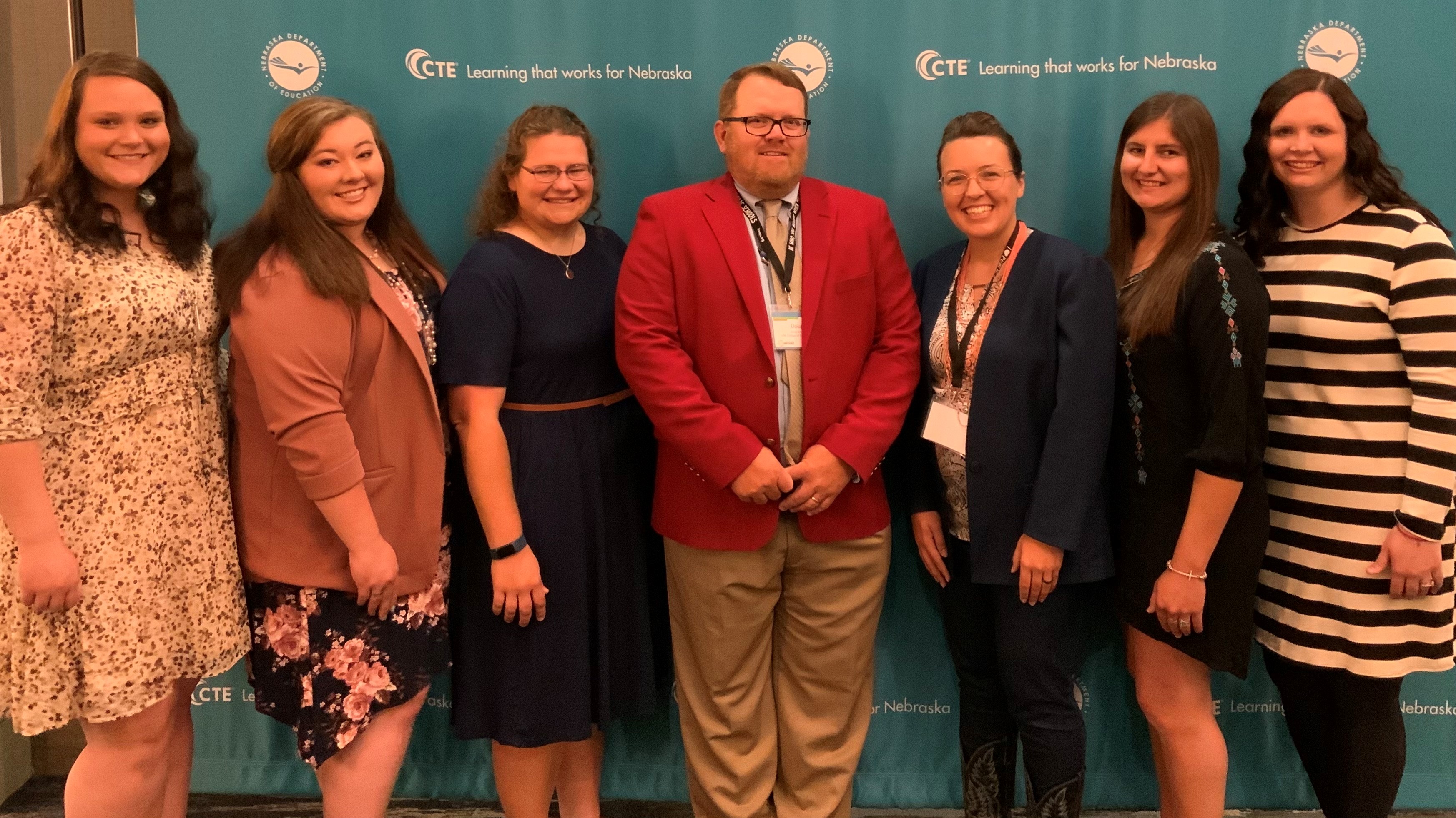 Six graduates of the Nebraska College of Technical Agriculture join Dr. Doug Smith during the Nebraska Agricultural Educators Association conference. Smith was honored for 10 years of teaching. From left, Amanda Schmidt, Kayla Mues, Kara Reimers, Smith, Katelyn Day, Evey Choat and Morgan Segner. The alumni are among 24 NCTA graduates currently teaching agriculture education. (Andela Taylor / NCTA)