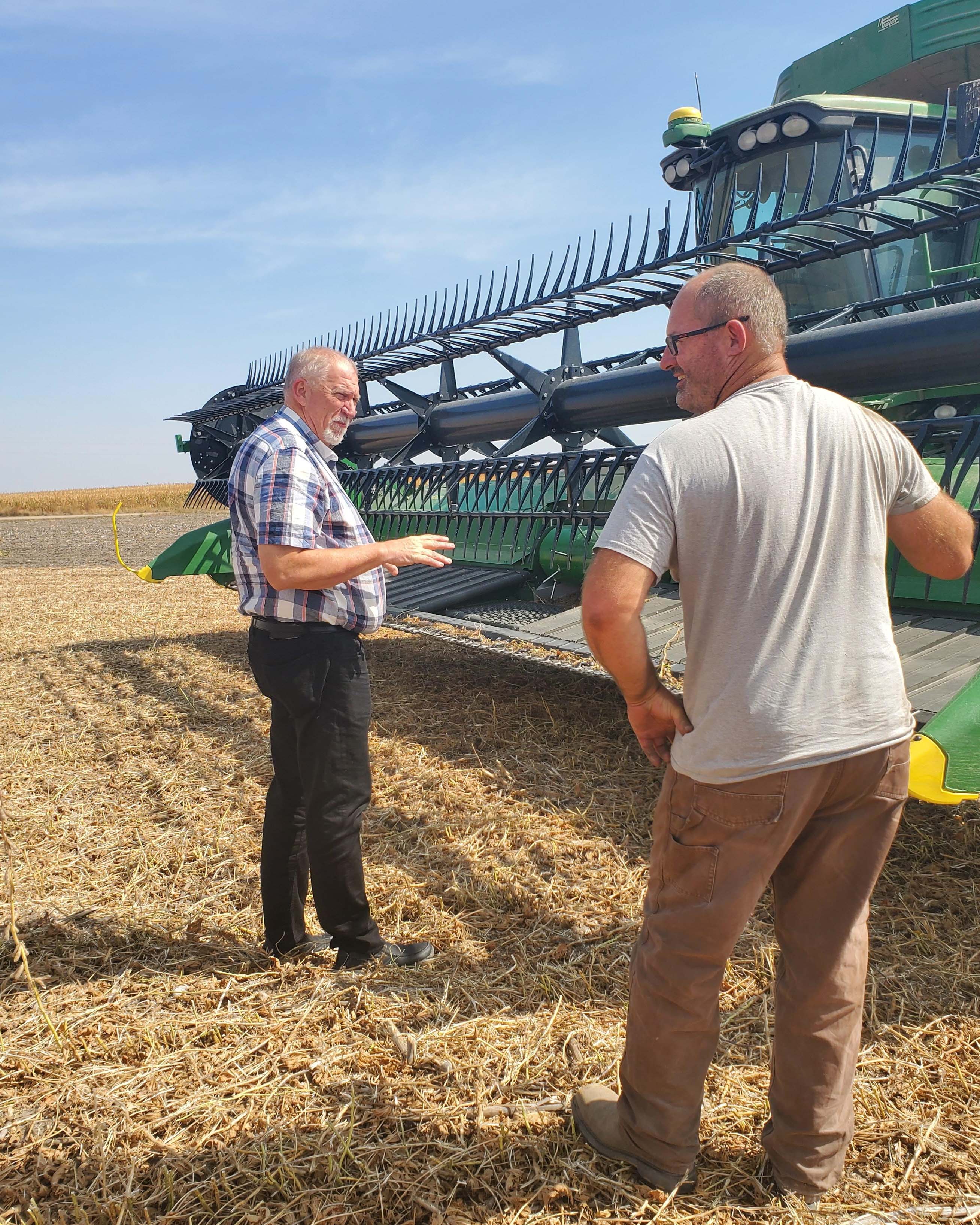 NCTA Dean Larry Gossen checks out harvest machinery with Kirk McConville of Indianola. (Photo by J. McConville / NCTA)