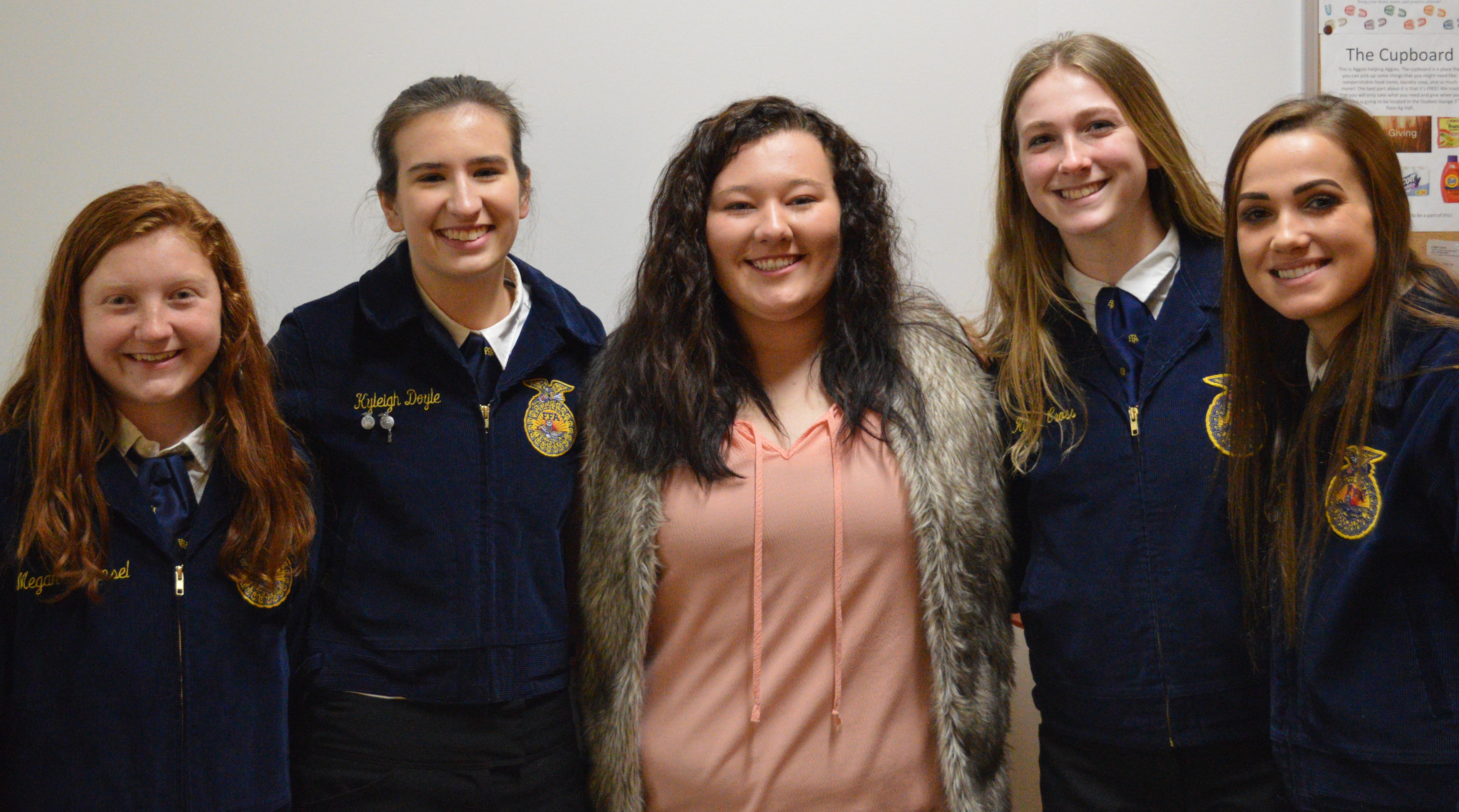 NCTA agricultural education major Kayla Mues of Cambridge visits with high school friends, Megan and Kyleigh, to her left, with Rylee and Taylor, to her right during a District 11 FFA contest in Curtis. Kayla is among NCTA Aggies assisting at FFA convention and contests in Lincoln this week. (Jocelyn Kennicutt / NCTA News photo)