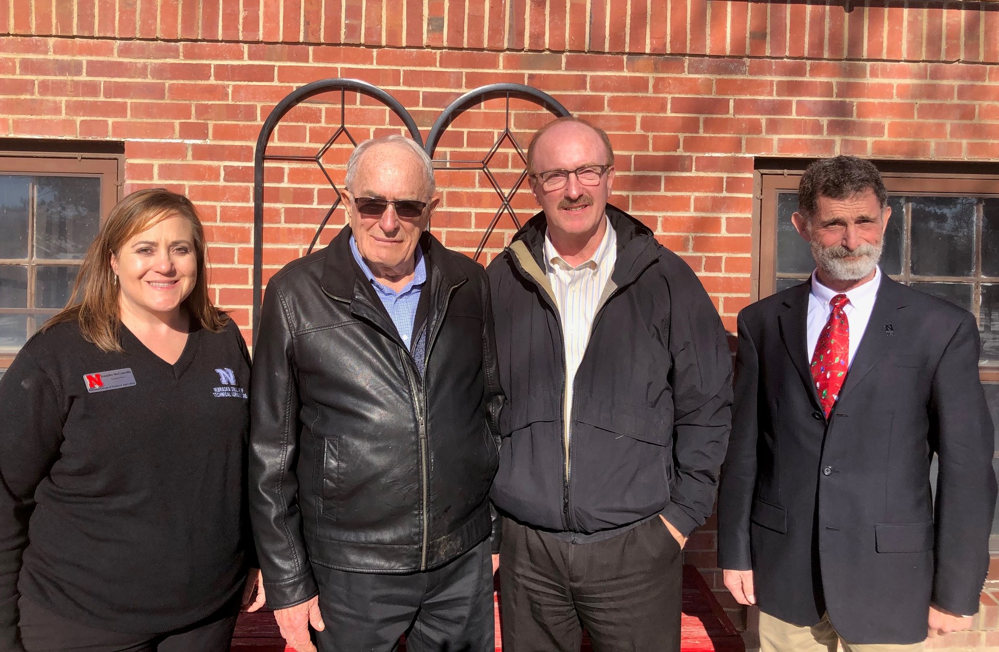 Meeting at the NCTA ag mechanics program in December, 2018, are Associate Dean Jennifer McConville, Claire and Byron Hansen, and NCTA Dean Ron Rosati.