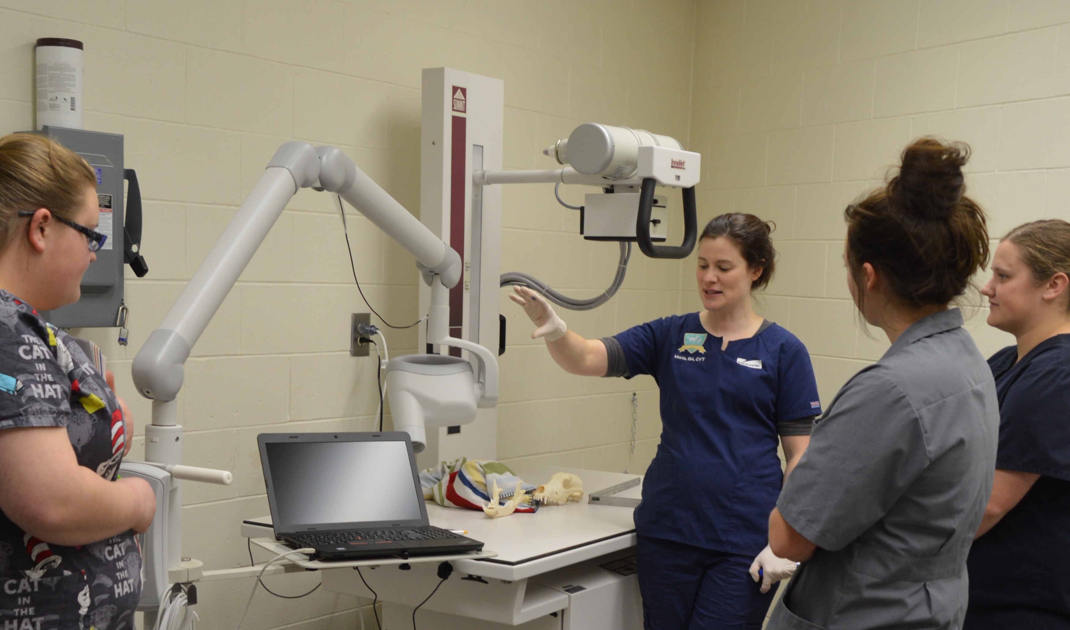 NCTA Vet Tech students receive training from Maria Nellessen, CVT, with Midmark Animal Health, on how to operate dental radiology equipment for small animals. From left, are students Emily Lamgo of Denver, Hanna Christenson of Ord, and Rebecca Wentz of Clayton, Kansas. (Hauptman/NCTA Photo) 