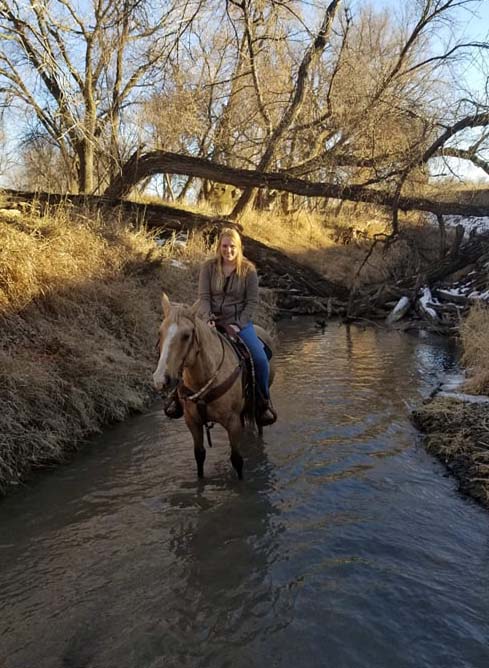 Huntra Christensen rides her horse, Sadie, at the NCTA Aggieland creek and pasture north of campus earlier this winter. (Photo by R. Porter/NCTA)