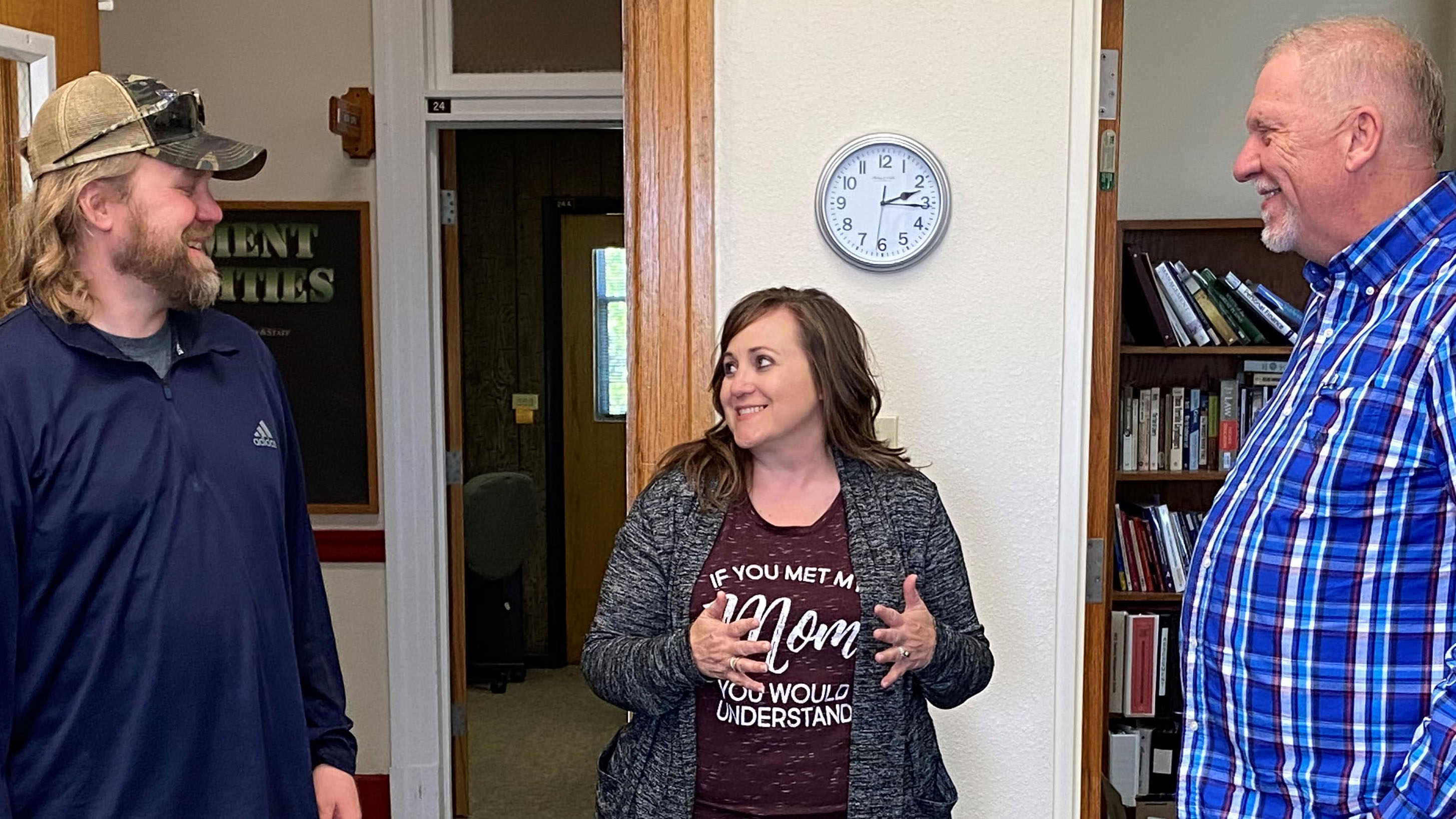 NCTA Dean Larry Gossen, on right, visits with Jeremy Sievers, agribusiness professor, and Associate Dean Jennifer McConville at Ag Hall during a visit in early May. (NCTA photo)