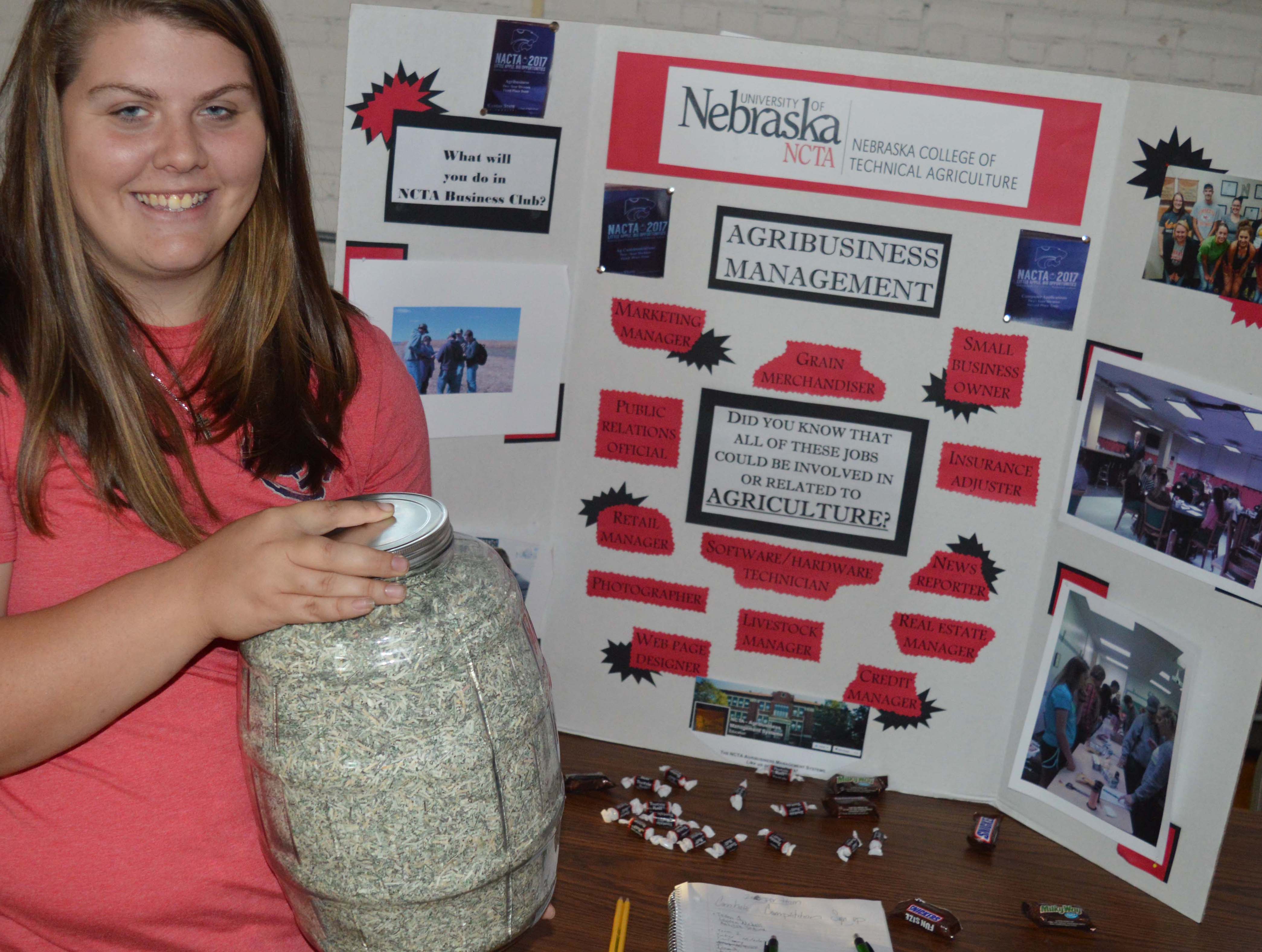 Kathryn Schick shows NCTA students what 8 pounds of shredded bills look like during a recent campus fair. (Crawford/NCTA News)