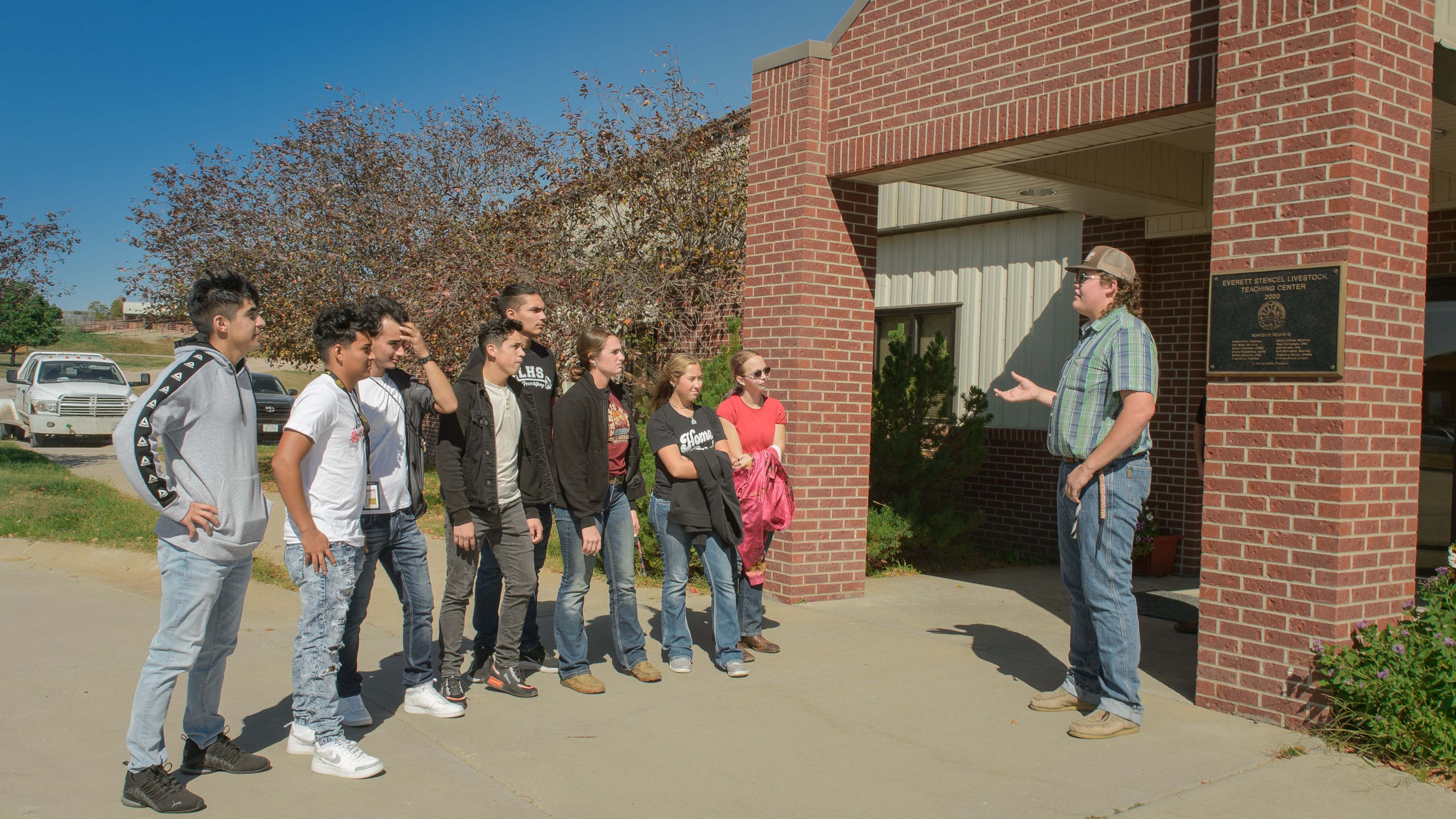 Aggie student ambassador Clayton Runkle gave a tour in October to students from Lexington, describing Animal Science and Equine Industry Management programs at the NCTA Livestock Teaching Center. (George Hipple / NCTA Photo) 
