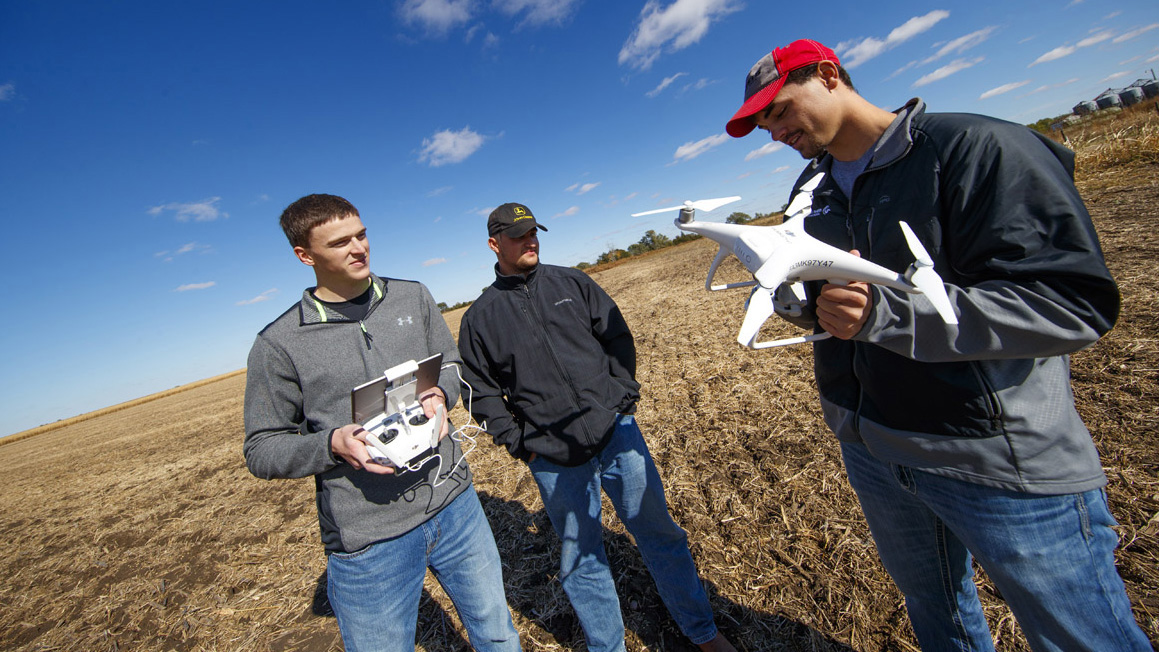 A file photo shows Aggie students learning to operate an aerial crop drone at the NCTA farm. (Craig Chandler / University Communication) 