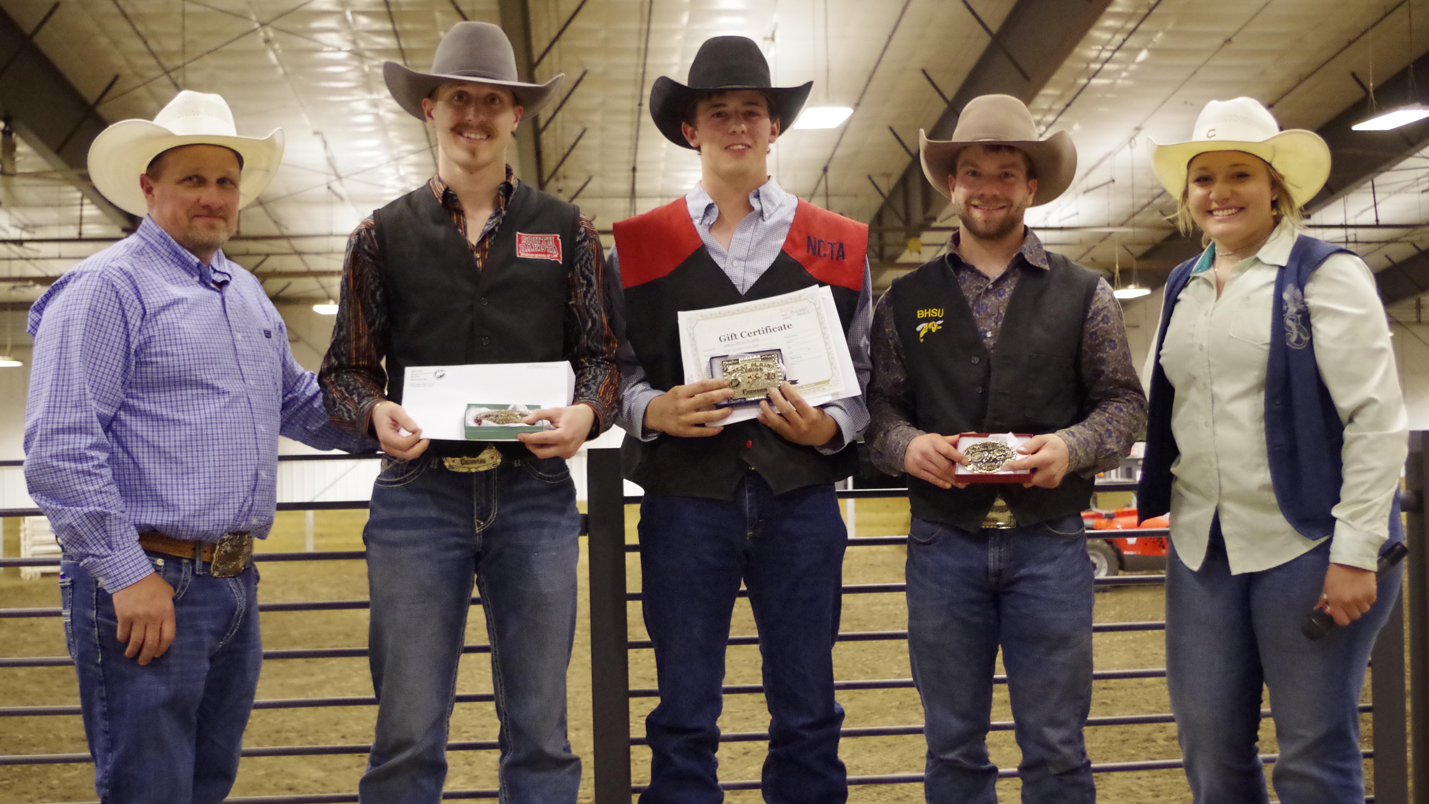 NCTA Aggie Rodeo student athlete Nathan Burnett of Shelton, Nebraska, center, won the Great Plains Region Saddle Bronc Riding title of the National Intercollegiate Rodeo Association. L-R, Ron Skovly South Dakota State University Rodeo Coach and GP Region Faculty Director; Paden Sexton, 2nd place, Nathan Burnett, regional champion; Tayte Goodman, 3rd place, and Jade Boote, Dickinson State, GP Student Director. (Courtesy photo by Penny Skovly) 