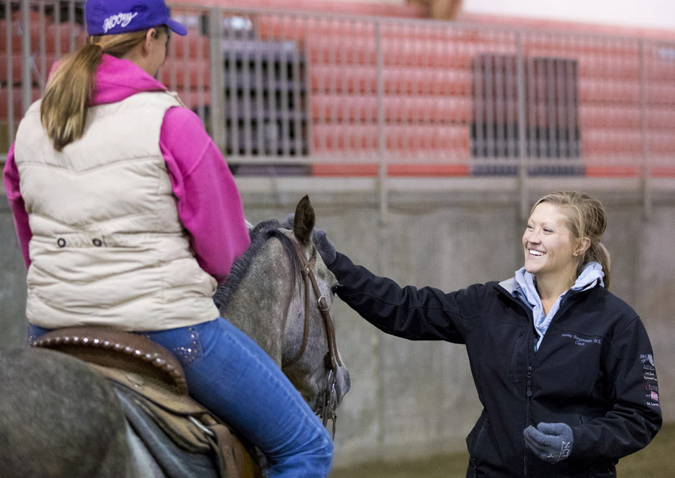 NCTA Professor Jo Hergenreder coaches a rider with the NCTA Ranch Horse Team during a workout on campus. (Photo by Craig Chandler / University Communication)