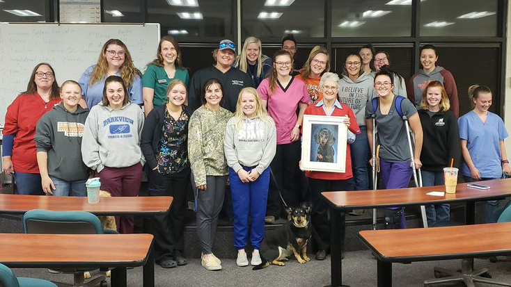 Vet Tech students in STVMA celebrate their instructor and mentor, Ricky Sue Barnes Wach, D.V.M., by presenting her with art. She retired in July and will continue on the NCTA faculty as a part-time lecturer. (C. Barnhart photo / NCTA)
