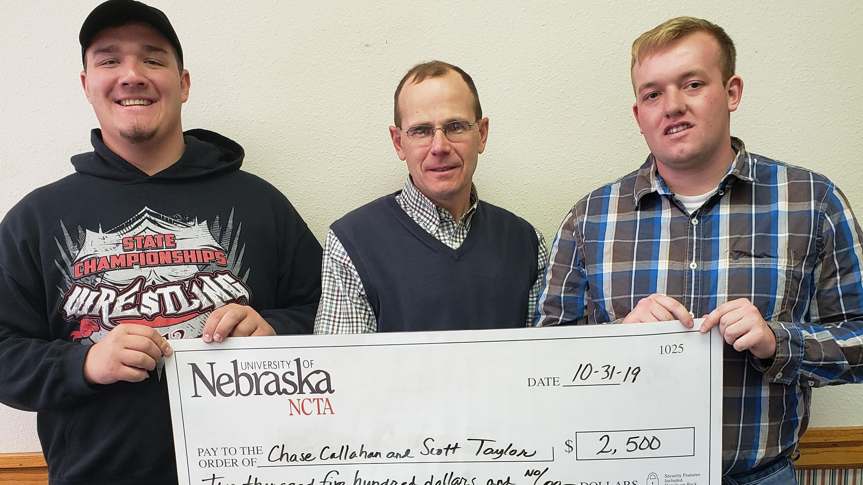 Scott Taylor of Curtis, left, and Chase Callahan of Farnam, right, each received a Sylvia Clawson/Hecht Scholarship presented last fall by NCTA Interim Dean Kelly Bruns. (NCTA photo)