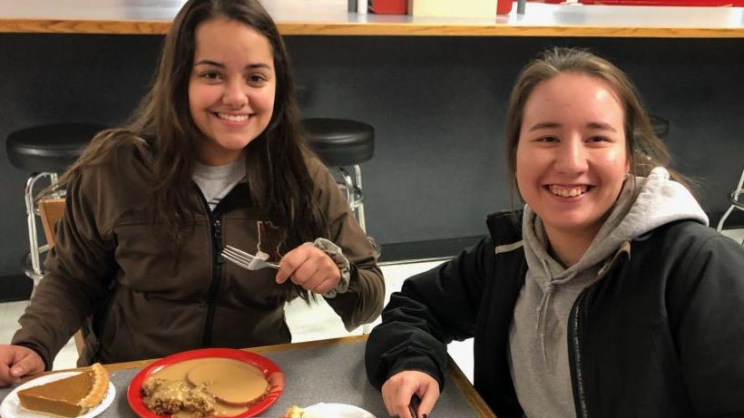 NCTA students Aaliyah Segura of Scottsbluff, left, and Courtney Anderson of Sioux Falls, South Dakota, enjoy a Thanksgiving meal at Aggie Dining before their holiday break. (Photo by NCTA student Annie Bassett)