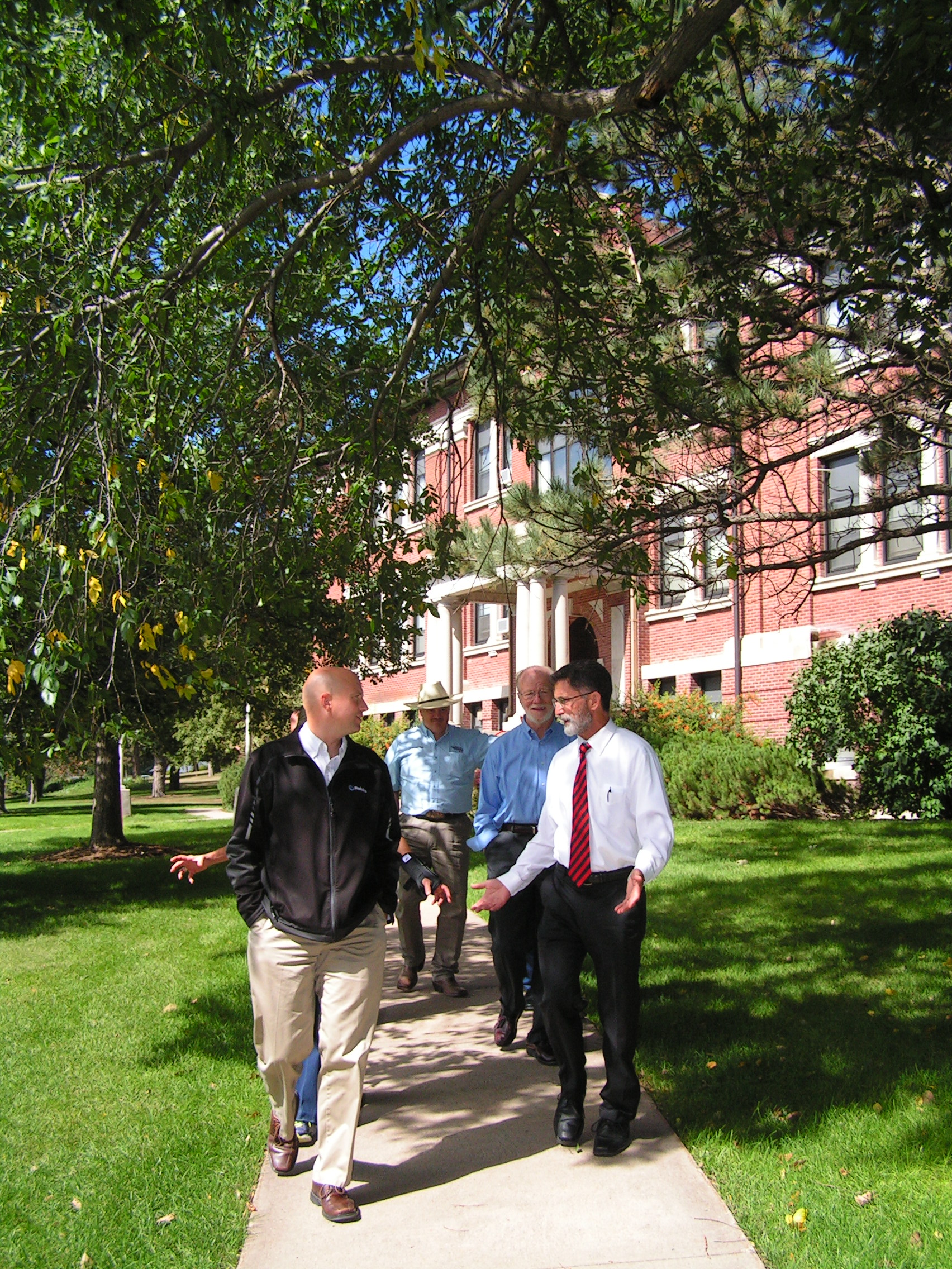 NCTA Dean Ron Rosati leads a campus tour below the huge trees near Ag Hall in 2014. (NCTA photo)