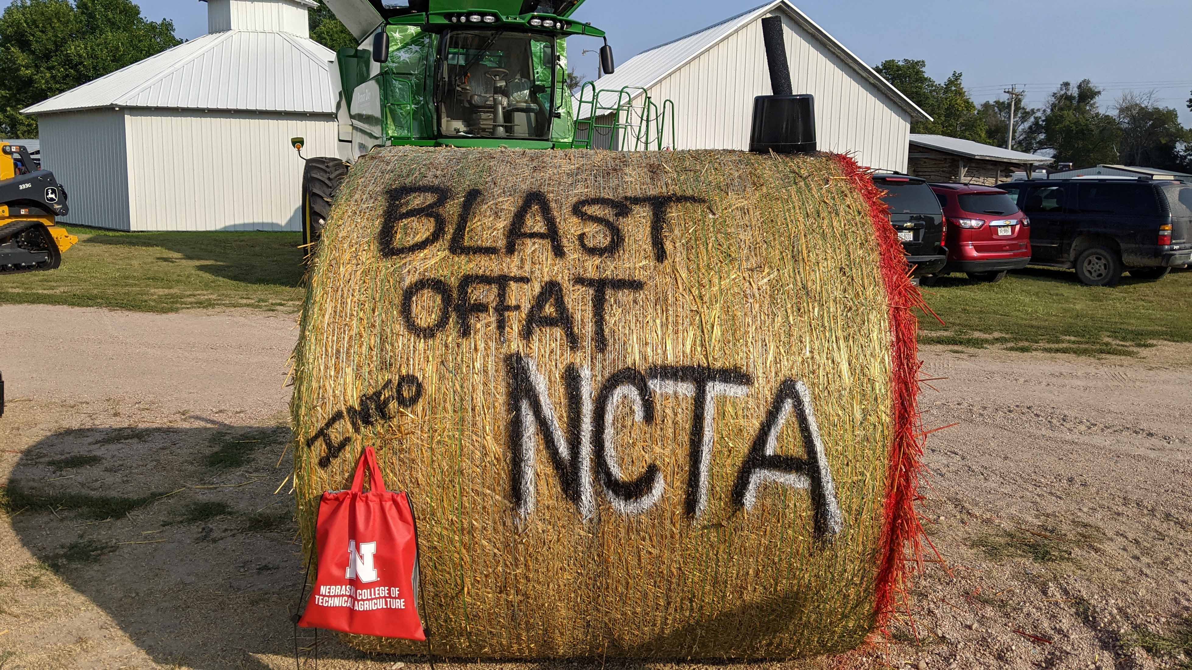 NCTA recruits with a hay bale at the Frontier County Fair in Stockville – with a 4-H rocketry project theme. (NCTA Photo / Gaylene Stinman) 