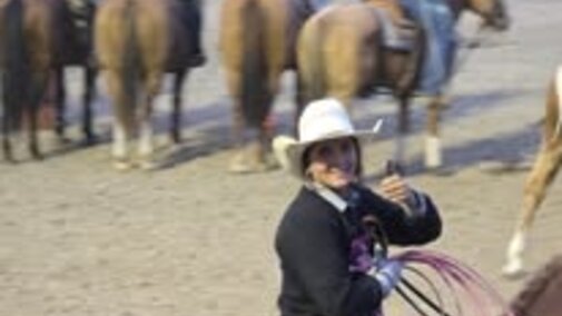 Student on horse giving a thumbs up