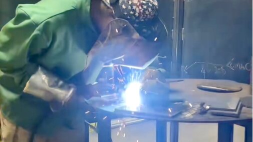 Ag Mechanics. Student is working on welding an item and is wearing protective gear.