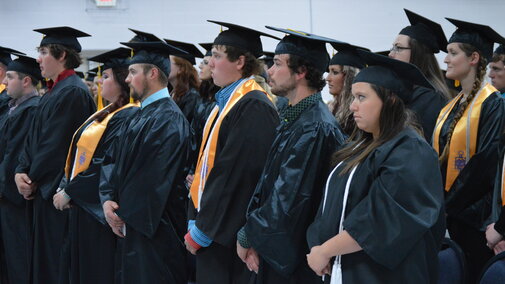 NCTA Class of 2016 graduates rise to move their tassels on their mortarboards from right to left. Governor Pete Ricketts was a keynote speaker for the May 5 commencement in Curtis. (NCTA photo)