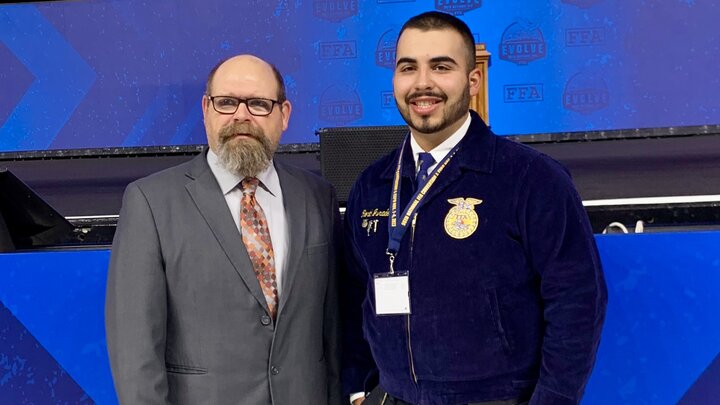 Jason Speck, FFA advisor at Chase County High School with Morel Jurado, an agribusiness major, pictured here celebrating Morelâs American Degree achievement. 