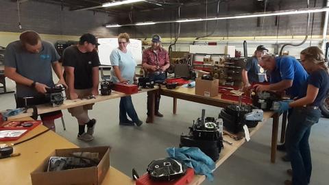 High school teachers at the 2021 NCTA Ag Mechanics Boot Camp work on small engines in a class with Dan Stehlik, second on right. The 2022 Boot Camp adds more topics and clinics for FFA coaches. (Andela Taylor / NCTA photo)