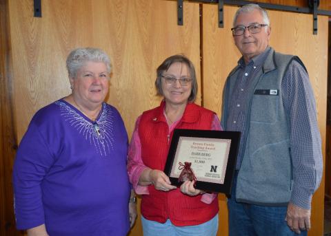 Barb Berg, center, receives the Bruntz Family Teaching Award from Ann and David Bruntz, UNSTA alumni.  (NCTA News photo)