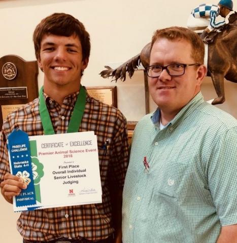 Camden Wilke of Columbus will begin his college career at NCTA in August. He visits with NCTA Animal Science professor and judging team coach Doug Smith after winning a livestock judging contest in Lincoln. Wilke is one of many recruits who visited NCTA this summer to register for classes. (NCTA photo)