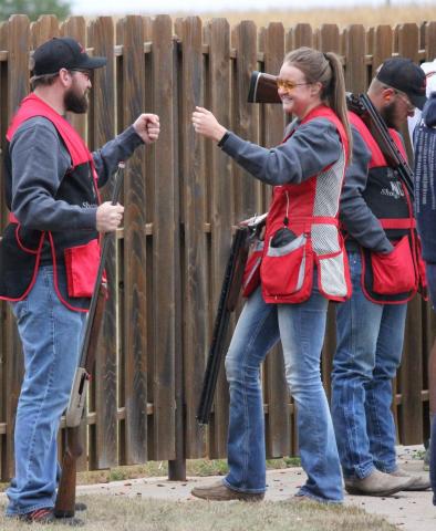 Top Aggie shooters Shawn Barger and Angela Crouse exchange a fist bump during a recent match. (Courtesy photo by Jody Crouse)