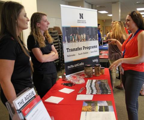 Recruiters discuss NCTA courses, teams and clubs with a prospective student.