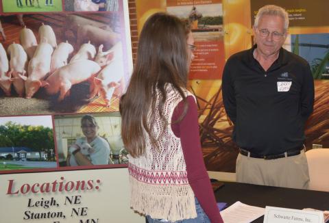 Katherine Schudel of North Loup visits with a representative of Schwartz Farms Inc. at the NCTA Career Fair in 2017. (NCTA Photo)