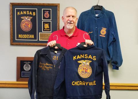 NCTA Dean Larry Gossen displays his FFA jackets as a Cherryvale Kansas chapter officer, a Southeast Kansas district treasurer, and on the wall is a chapter advisor jacket. He has attended the National FFA Conventions since 1977. (McConville / NCTA photo)