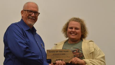 NCTA Dean Larry Gossen presents the Aggie of the Year plaque to Maddy Carr in May. (Crawford / NCTA photo)