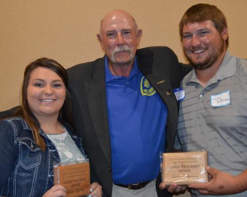 Paige Twohig and Lucas Kolterman received "Leave Your Mark" awards from the Aggie Alumni Association, presented by NCTA alumnus and instructor Dan Stehlik. (NCTA Photo)