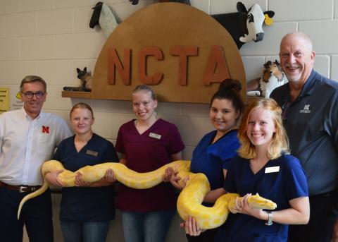 UNL Chancellor Ronnie Green joins NCTA veterinary technology students and NCTA Dean Larry Gossen with a highlight of any VT tour, Monty python. (Photo by Melody MacDonald / NCTA student)