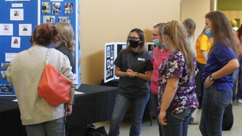 Veterinary Technology students wearing their "scrub tops" staff a booth and share Discovery Day information about careers in animal health. (NCTA Photo)