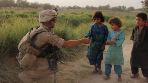 Infantryman Wade Shipman greets youngsters in Afghanistan during one of his deployments with the U.S. Marines. (Courtesy photo)